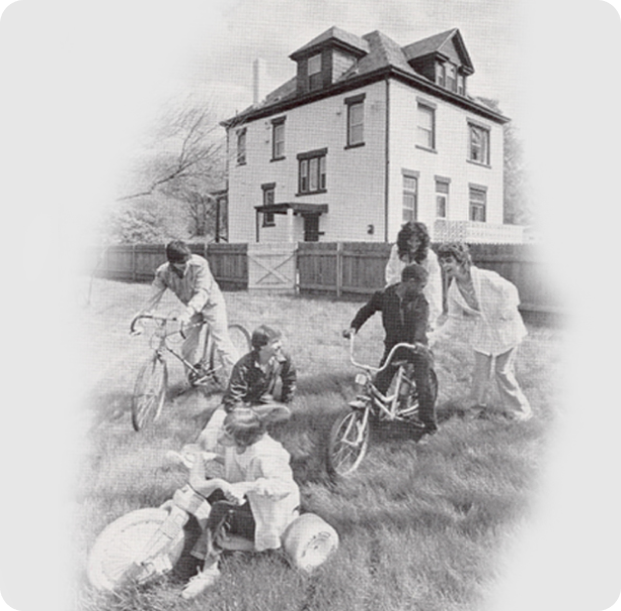 Old fashion black and white image of children on bikes in grass Old fashion black and white image of children on bikes in grass