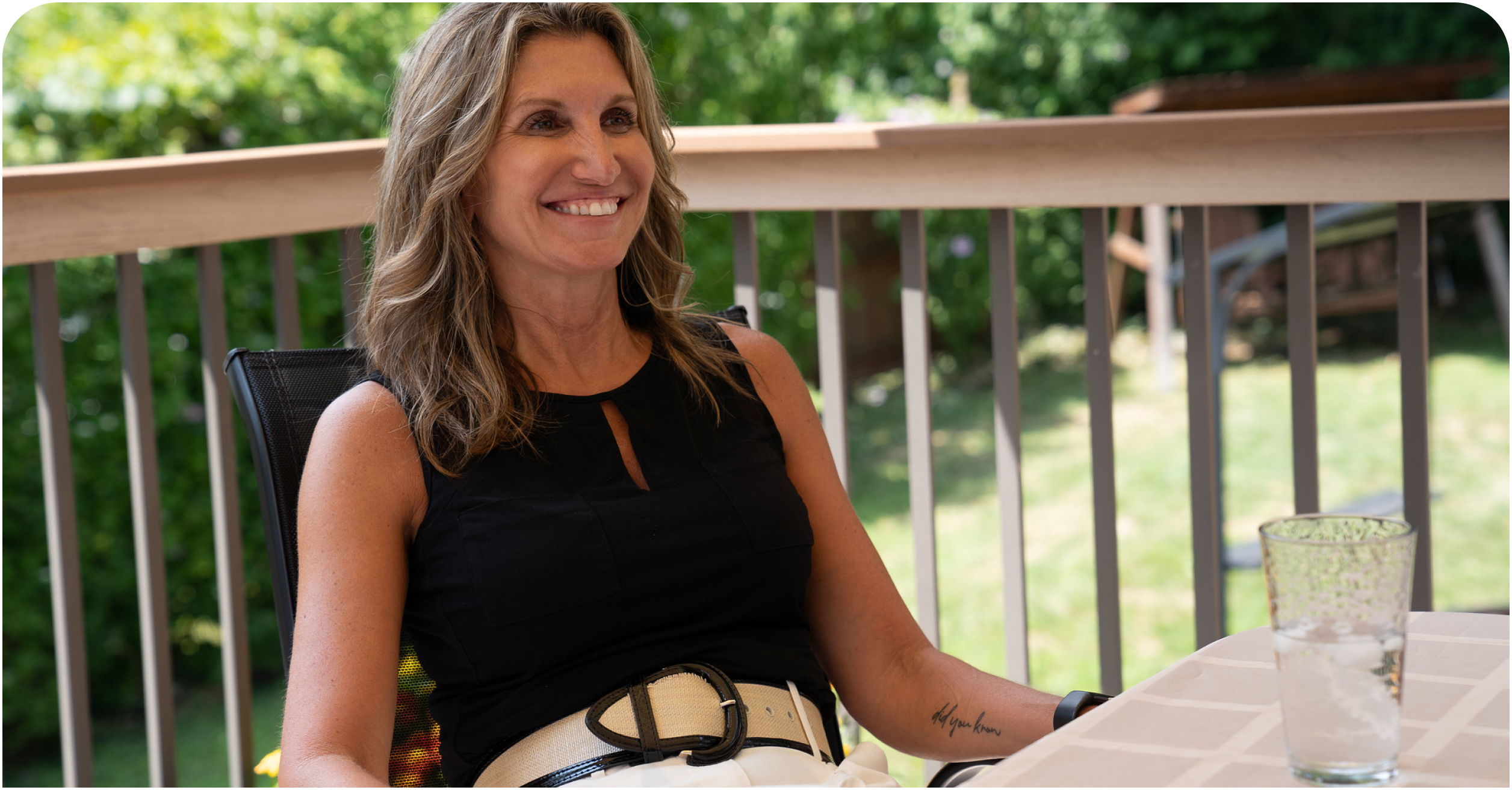Mainstay CEO Kim smiling while relaxing on a front porch