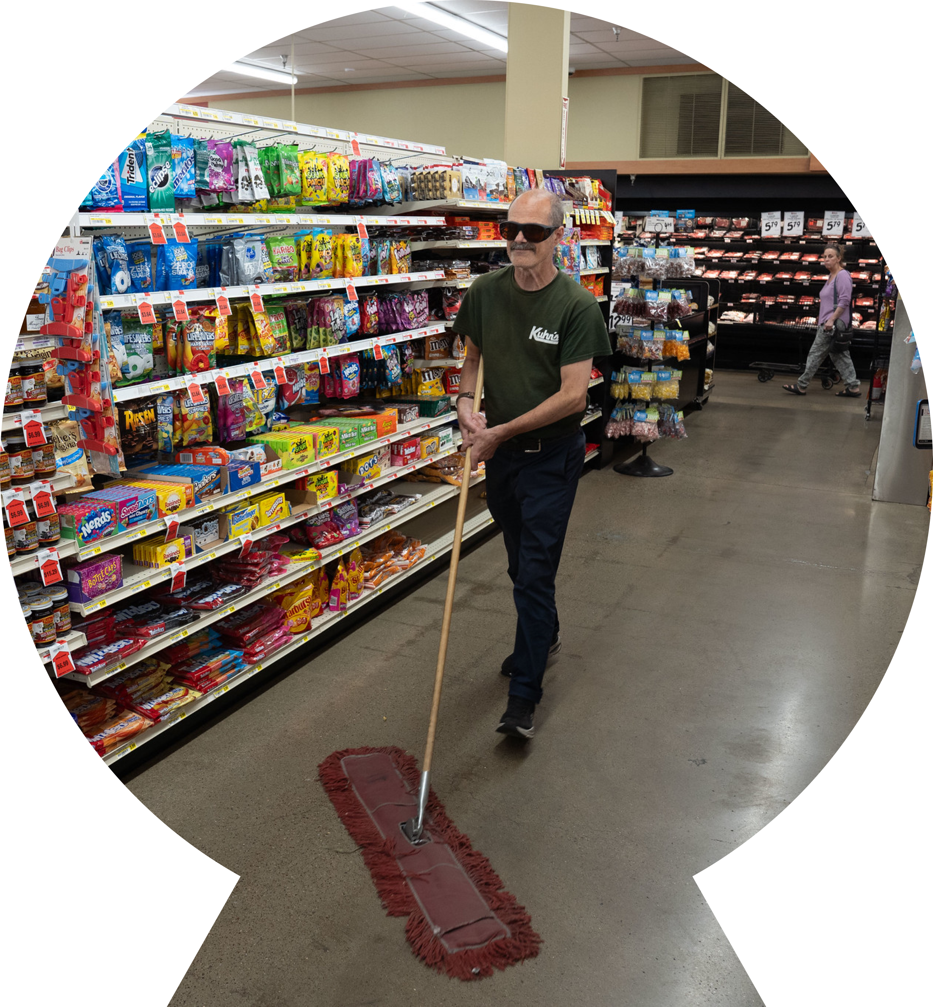 Man mopping the aisle floors of a grocery store, while working. Man mopping the aisle floors of a grocery store, while working.